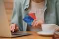 Woman with credit cards using laptop for online shopping at wooden table, closeup Royalty Free Stock Photo