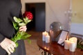 Woman with cremation urn at funeral in church