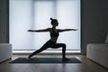 Woman in crescent lunge twist position on mat