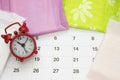 Woman critical days, gynecological menstruation cycle, blood period. Menstrual sanitary soft pads, calendar and a clock. Woman hyg