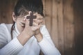 Woman with  cross  in hands praying for blessing from god  in the morning, spirituality and religion Royalty Free Stock Photo