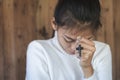 Woman with  cross  in hands praying for blessing from god  in the morning, spirituality and religion Royalty Free Stock Photo