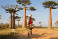 Woman crosses the alley of Baobab