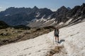 Woman Crosses Snow Patch toward Paintbrush Divide Royalty Free Stock Photo