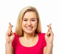 Woman Crossing Fingers Against White Background