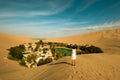 woman crossing The Huacachina Oasis, in the desert sand dunes near the city of Ica, Peru Royalty Free Stock Photo