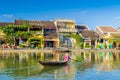 Woman crossing a river on a boat in Hoi An