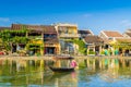 Woman crossing a river on a boat in Hoi An