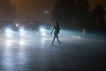 Woman crossing road in fog