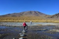 Woman crossing a stone bridge in BOlivia