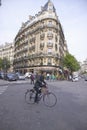 Woman crossing street on bicycle, Paris, France Royalty Free Stock Photo