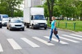 Woman crossing the street at pedestrian crossing Royalty Free Stock Photo