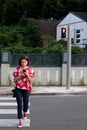 Woman crossing the street on red light