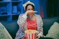 Woman cry while watching a very moving movie with popcorn at night. Royalty Free Stock Photo