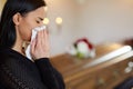 Woman crying near coffin at funeral in church Royalty Free Stock Photo