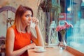 Woman crying wiping tears sneezing in a tissue drinking tea