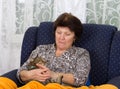 Woman cuddles cat