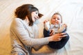 Woman cuddling with her adorable baby, sweet kid smiling at camera Royalty Free Stock Photo