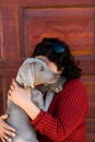 Woman cuddling pet dog