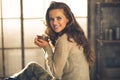 Woman with cup of coffee in loft apartment Royalty Free Stock Photo