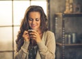 Woman with cup of coffee in loft apartment Royalty Free Stock Photo