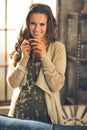 Woman with cup of coffee in loft apartment Royalty Free Stock Photo