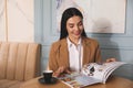 Woman with cup of coffee reading magazine in morning Royalty Free Stock Photo