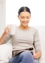 Woman with cup of coffee reading magazine at home Royalty Free Stock Photo