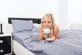 Woman cup of coffee smell closed eyes dream on bed