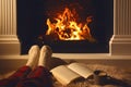 Woman with cup of drink and book near fireplace at home, closeup Royalty Free Stock Photo