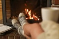 Woman with cup of hot cocoa near fireplace Royalty Free Stock Photo