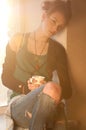 Woman with cup of hot coffee over sun window Royalty Free Stock Photo