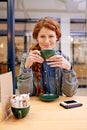 Woman, cup and smile in coffee shop for portrait at breakfast to start morning at table. Girl, person and happy in Royalty Free Stock Photo