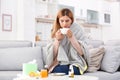 Woman with cup of tea for cough on sofa Royalty Free Stock Photo