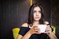 Beauty Woman with cup of tea has a rest at the coffee bar Royalty Free Stock Photo