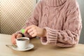 Woman with cup of tea at wooden table, closeup Royalty Free Stock Photo