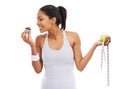 Woman, cupcake and apple smile for sweets in studio for healthy decision, choice or diet balance. Female person, dessert