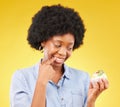 Woman, cupcake and studio with thinking, diet and temptation for guilt with junk food by yellow background. African