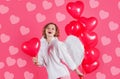 Woman cupid angel with balloons. Valentines day advertising. Happy girl with red heart shape balloon. Royalty Free Stock Photo