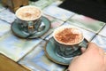 Woman with cups of fresh coffee at table Royalty Free Stock Photo