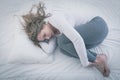 Woman curled up in bed Royalty Free Stock Photo