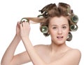 Woman curling her hair with roller Royalty Free Stock Photo