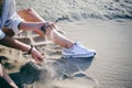 Woman with curly hair, the romance of youth, a journey walk on a warm summer sunny day on a sandy beach with water Royalty Free Stock Photo