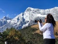 Woman with curly hair shooting on camera of beautiful panorama Royalty Free Stock Photo