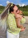 A woman with curly hair on a walk with a dog on the shore of the Baltic Sea Royalty Free Stock Photo