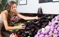 Woman customer buying organic eggplant in shop Royalty Free Stock Photo