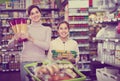 Woman customer with girl looking for pasta in supermarket Royalty Free Stock Photo