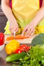 Woman cut carrot Royalty Free Stock Photo