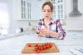 Woman cut finger with knife while cooking in kitchen Royalty Free Stock Photo