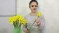 Woman cut shorter stems of daffodils